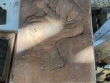 a stone carving of a man kneeling on a bench
