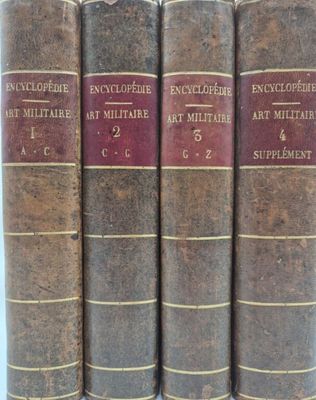 four old books are lined up in a row on a table