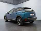 the rear end of a blue suv parked in a garage