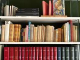 many books that are on the shelves in the room