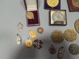 a lot of gold and silver medals on a table