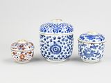 three blue and white vases with lids and lids sitting on a table