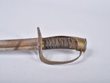 an old sword with a wooden handle on a white surface