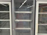 two empty refrigerators that are in a store