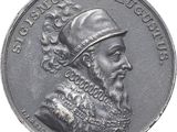une vieille pièce d'argent à l'effigie d'un homme coiffé d'un chapeau