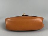 an orange leather purse with a gold clasp