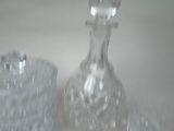 two glass vases sitting on a table next to each other