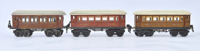 trois petits trains posés sur une surface blanche
