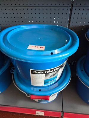 several blue plastic buckets are stacked on a shelf in a store