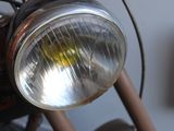 a close up of a motorcycle with a light on it ' s headlight