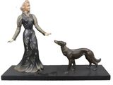 statue of a woman and a dog on a black base