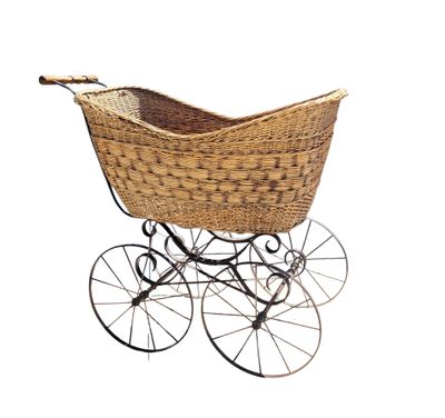 an old fashioned wicker baby carriage with wheels and a basket on top