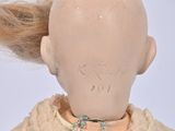 a doll that has a hair on it ' s head