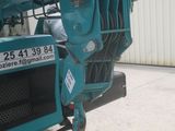 an image of a blue truck parked in front of a building