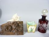 two vases and a bottle of perfume on a table