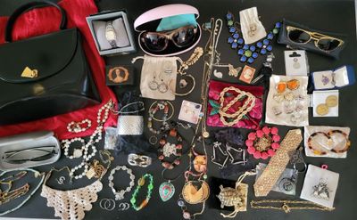 a black table with a bunch of jewelry on it