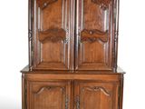 an old wooden cabinet with two doors and two drawers