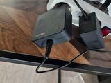 a table with a laptop and a charger on it