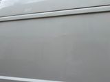 a close up of a white van with the door open