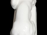 a white statue of a cat on a black background