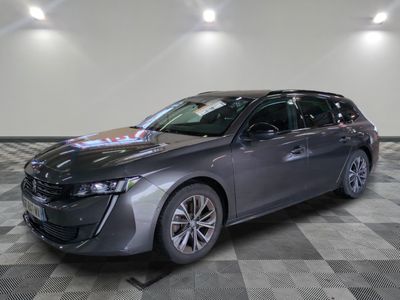 a grey car parked in a garage with a checkered floor