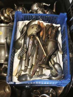 a blue basket filled with silverware and spoons