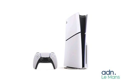 a white video game console next to a black and white video game controller