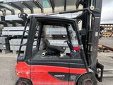 a red fork truck parked in front of a building