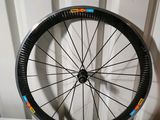 a bicycle wheel with stickers on it sitting on a table