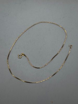 a gold chain with a clasp on a white background