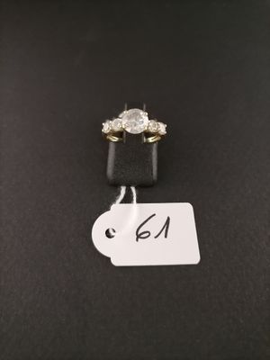 a close up of a diamond ring on a black surface