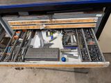 a drawer full of tools that is sitting on the floor