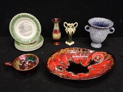 many pieces of pottery sitting on a black table