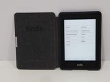 a kindle next to a kindle book on a table