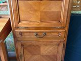 a wooden cabinet that has a drawer on top of it