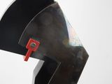 a sculpture of a helmet on a wooden base