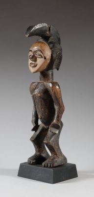 a wooden statue of a man with a helmet on his head