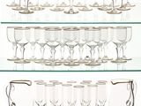 a glass shelf that has a lot of wine glasses on it
