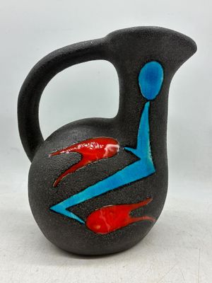 a black vase with a blue and red design on it