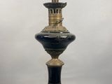a black and gold vase sitting on top of a table