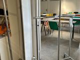 a room with a table and chairs and a umbrella on a stand
