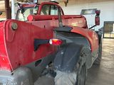 a large red truck that is parked in a garage