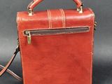 an image of a small brown leather bag with a strap