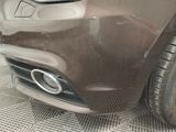 a close up of a car ' s front bumper and exhaust pipe