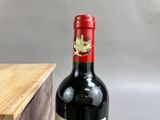 a bottle of wine sitting next to a wooden box