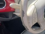 dashboard of a car with a steering wheel and dashboard controls