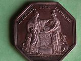 a coin with a picture of a man and woman on it