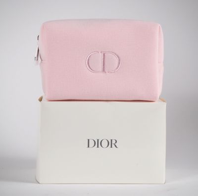 a pink and white toilet bag sitting on top of a white box
