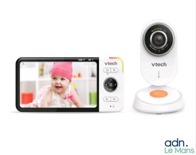 a close up of a baby monitor sitting next to a cell phone