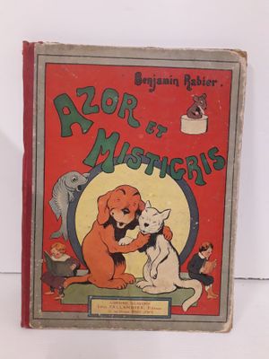 un vieux livre pour enfants sur lequel figurent un chien et un chat